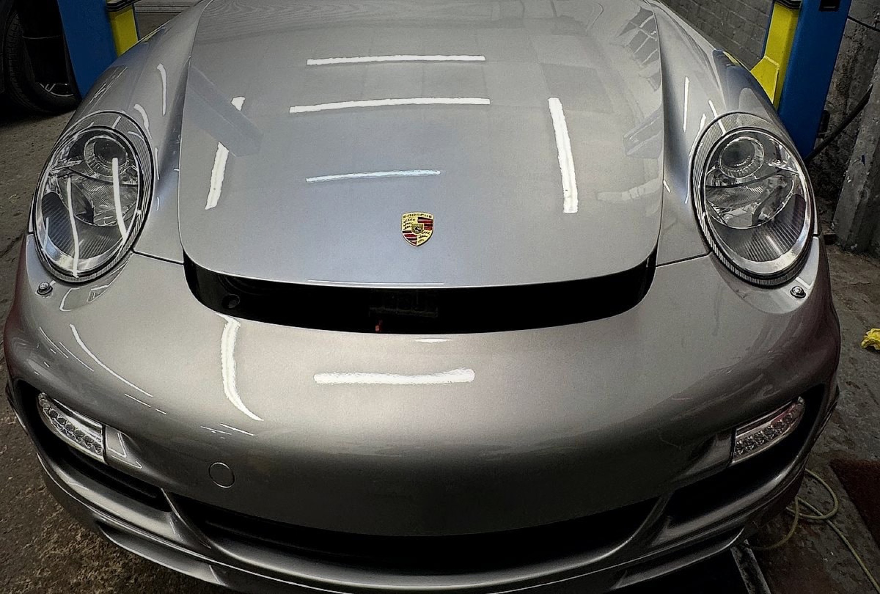 Porsche paint correction finish inside detailing workshop